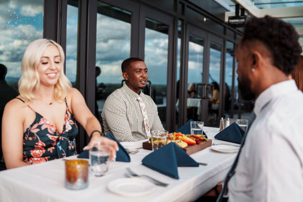istock Friends on double date having dinner together outdoors at restaurant 2181566943