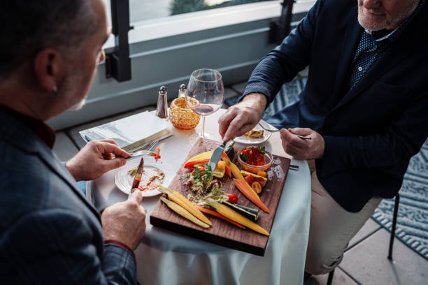 Gay couple sharing appetizer at upscale restaurant