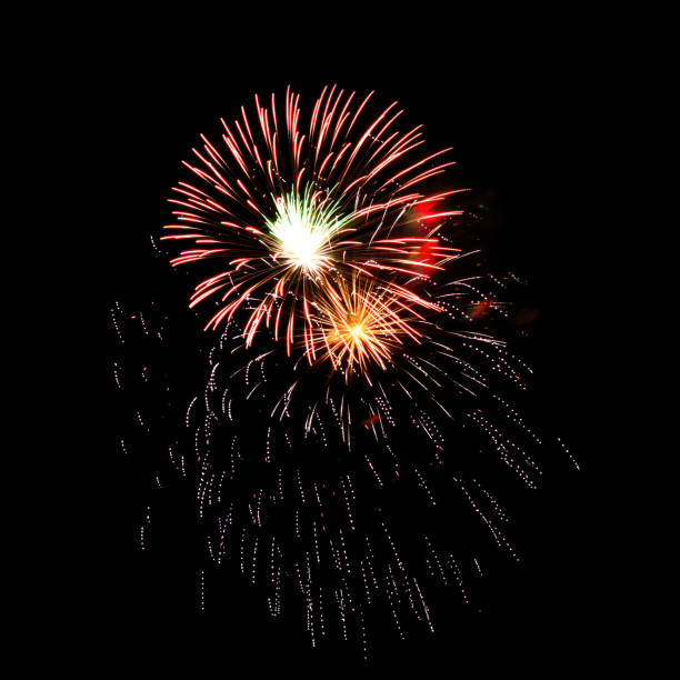 Colorful celebration fireworks isolated on a black sky background.