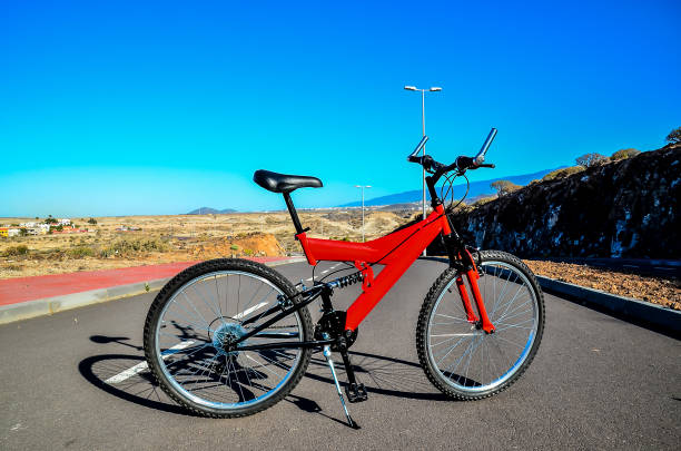 istock A red mountain bike is parked on a road 2181568559