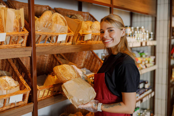 istock A Friendly Baker Showcasing a Beautifully Fresh Bread Display at a Welcoming Local Store 2181569432