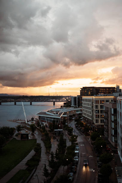 View of a beautiful sunset over the Columbia River and riverfront park from the rooftop terrace of a restaurant in Downtown Vancouver, Washington.