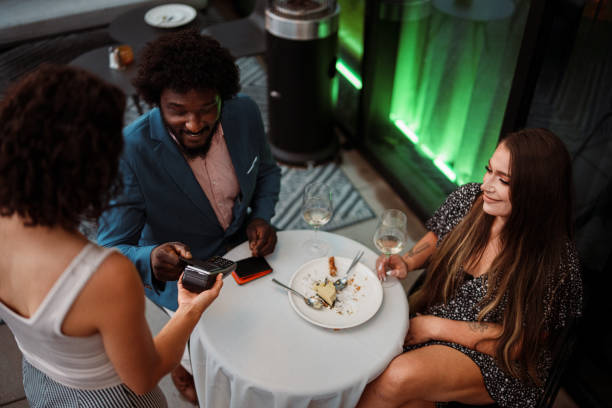 istock Man using credit card to pay for dinner out 2181569913