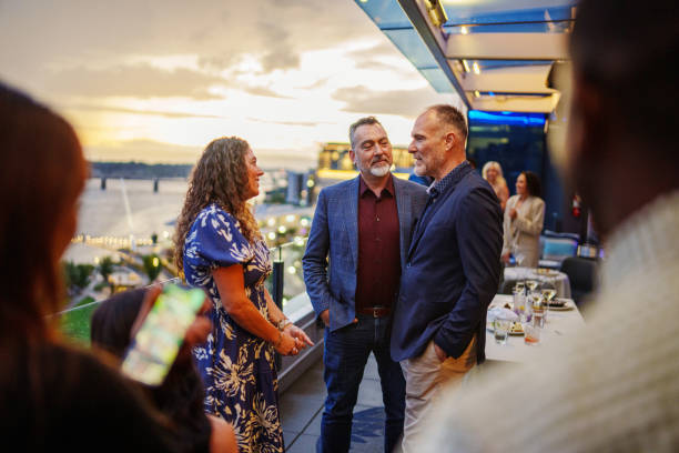 istock Couple talking with a friend after dinner on restaurant patio 2181569933