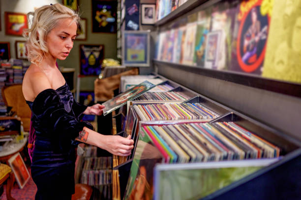 istock Young woman browsing vinyl records in a retro-style record store. 2181570268