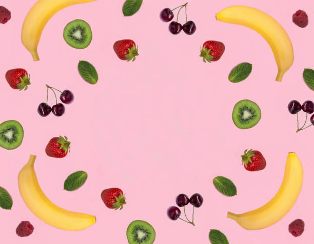 Fruit and berry on the pink background. Top view. Copy space.