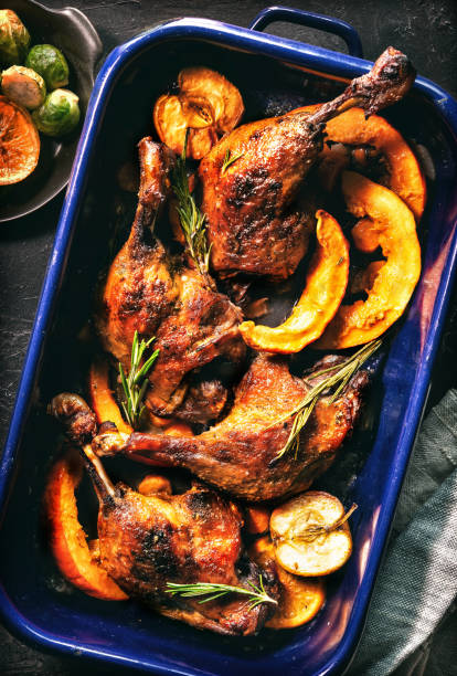 istock Duck legs roasted with apples, oranges and squash slices in a roasting pan . Cooking at Christmas time 2181572429