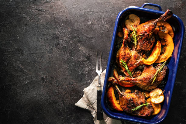 istock Duck legs roasted with apples, oranges and squash slices in a roasting pan . Cooking at Christmas time 2181572434