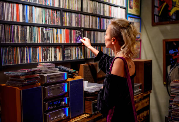 istock Young woman browsing CDs in a retro-style record store 2181573051
