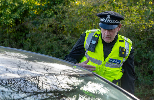 istock UK police officer approaching a parked car 2181575346