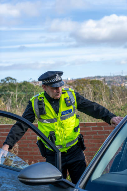 istock UK police officer approaching a parked car 2181575387
