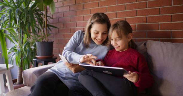 istock Little Sisters Using Digital Tablet, And Having Fun Together 2181575426