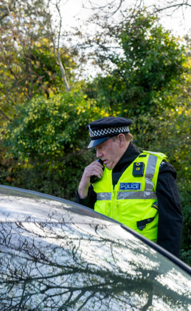 istock UK police officer approaching a parked car 2181575501