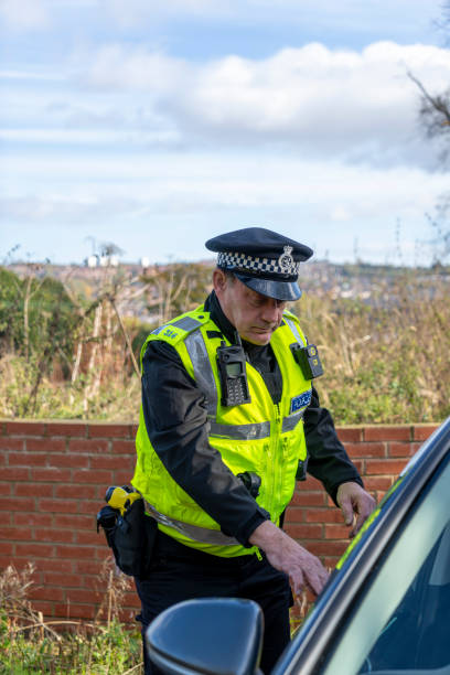 istock UK police officer approaching a parked car 2181575542