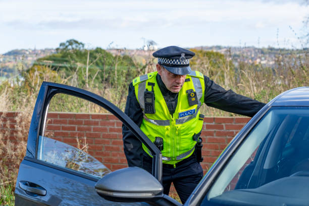 istock UK police officer approaching a parked car 2181575622