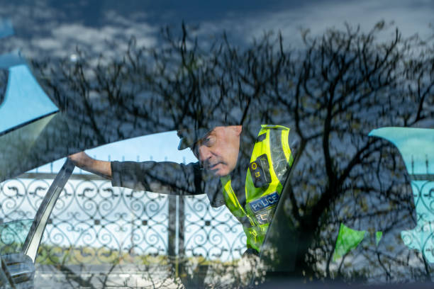 istock UK police officer approaching a parked car 2181575634