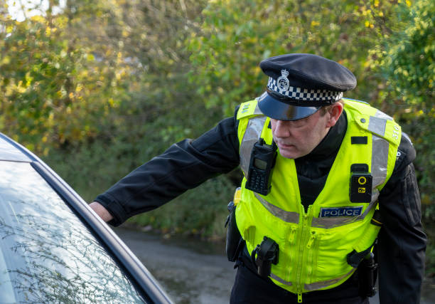 istock UK police officer approaching a parked car 2181575656