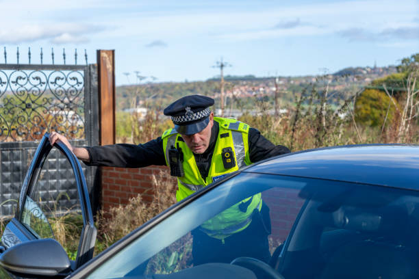 istock UK police officer approaching a parked car 2181575686