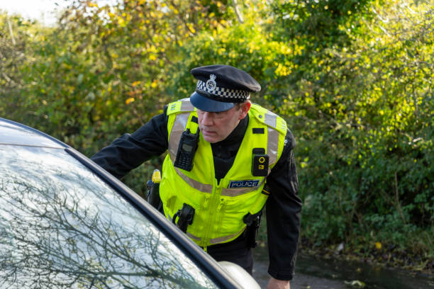 istock UK police officer approaching a parked car 2181575854