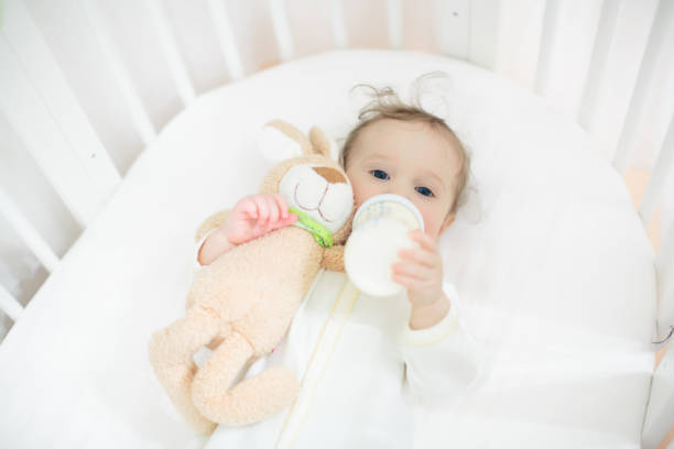 istock Little baby on white bed 2181577770
