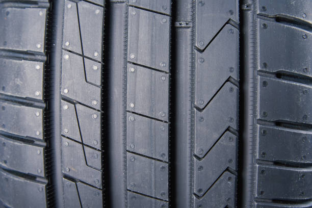 Close-up of off-road tire surface,A Textured Surface: Close-up of a Tire Tread Pattern with Dirt