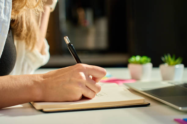 istock Illustrator drawing sketches in notebook at home office desk 2181580993