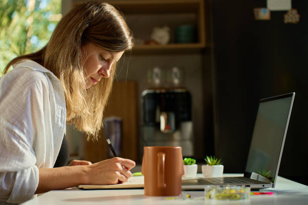 istock Illustrator drawing sketches in notebook at home office desk 2181580995