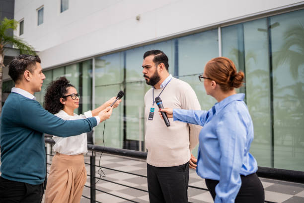 istock Mature man talking to journalists outdoors 2181581784