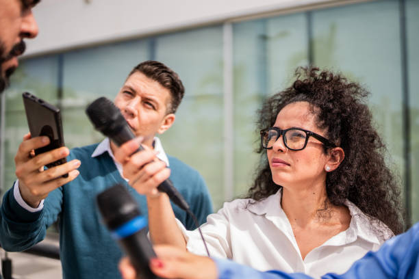 istock Journalists interviewing man outdoors 2181581850