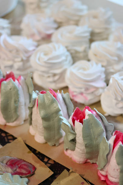 Homemade marshmallows are spread out on the table surface. They are setting and stabilizing before packaging.