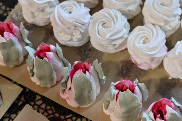istock Homemade marshmallows are spread out on the table surface. They are setting and stabilizing before packaging. The marshmallows are classic. Marshmallow tulips. 2181581926