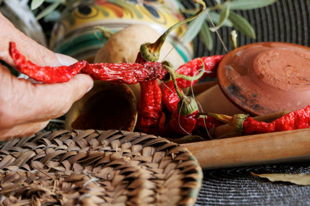 istock Beautifully Dried Red Chilies Alongside Traditional Pottery Set Against a Textile Background 2181583111