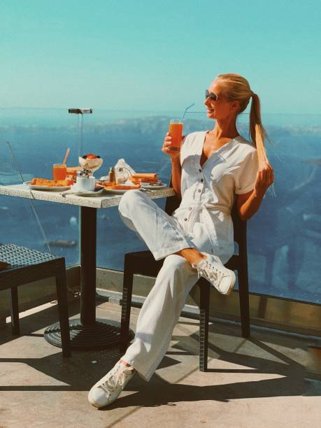 istock Beautiful girl having breakfast with sea view 2181585824