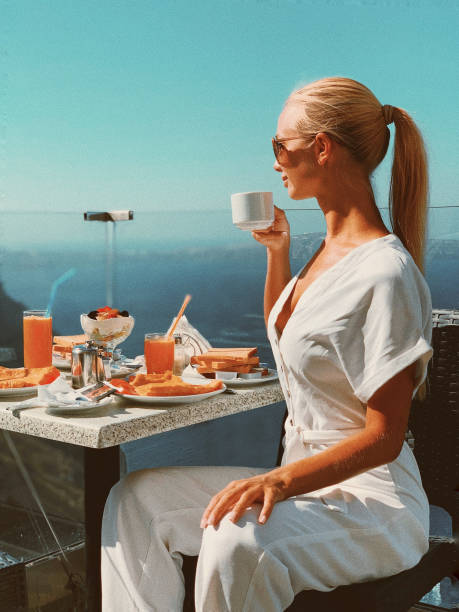 istock Beautiful girl having breakfast with sea view 2181585894