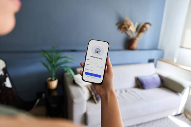 istock Woman holding smartphone and using mobile banking application at home, innovative online banking service 2181589182