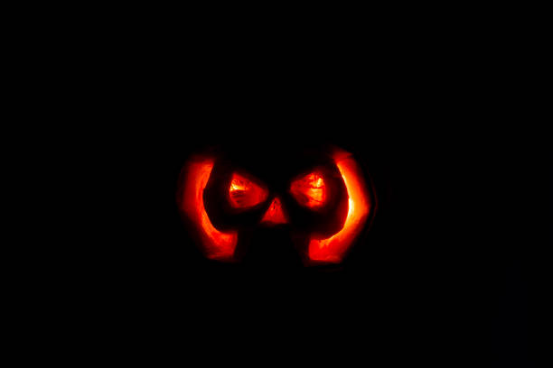 istock Halloween Pumpkin Skull silhouette glowing orange 2181589923