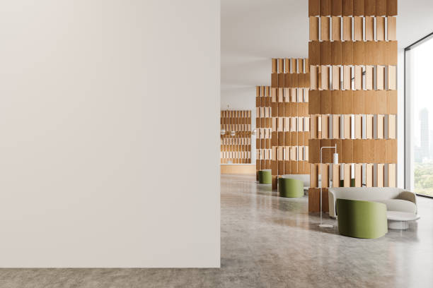 istock Light office interior with reception desk and relax zone, window. Mockup wall 2181592580