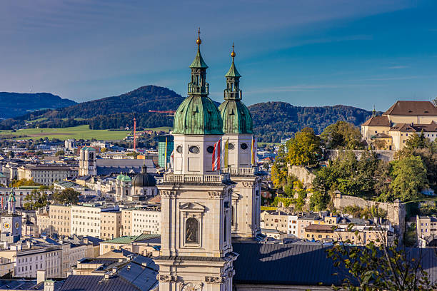Salzburg cityscape of churches, castle, bridge and beautiful cityscape with the mountains on the background. Salzburg famous city sights and tourist attraction in Austria