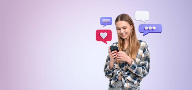 istock Smiling woman using smartphone with message icons on pastel back 2181594597