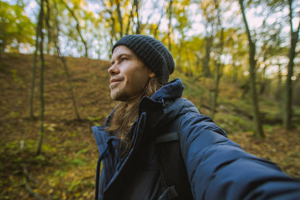 istock Man taking selfie in forest. Solo travel 2181594757