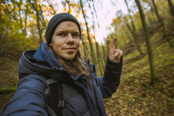 Man taking selfie in forest. Solo travel