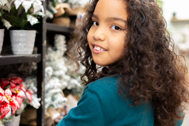 istock Smiling girl choosing christmas decorations in a store 2181598859