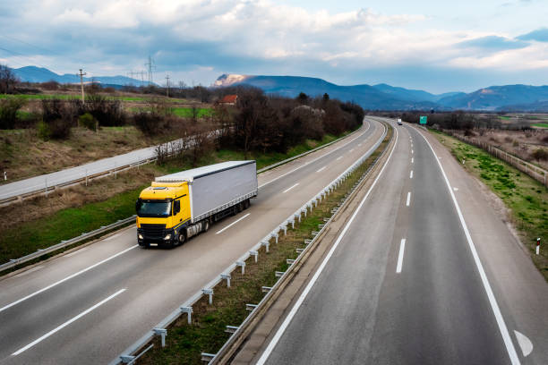 istock Big orange truck with a grey trailer 2181602438