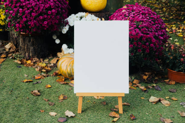 istock Blank canvas displayed on an easel in a vibrant autumn garden setting, mock up 2181621533