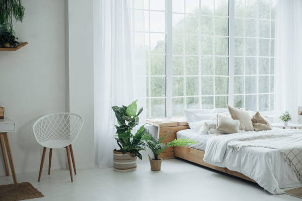 istock Bright and airy modern bedroom with plants and large windows in a serene home setting 2181622200