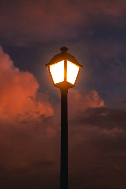 A Glowing Street Lamp Illuminates The Dramatic Evening Sky, Casting Warm Light Against Clouds In Old San Juan, Puerto Rico.