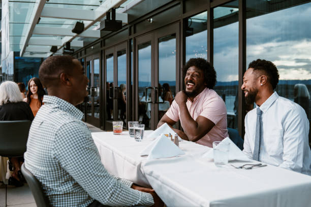 istock Male friends enjoying dinner out together 2181636356