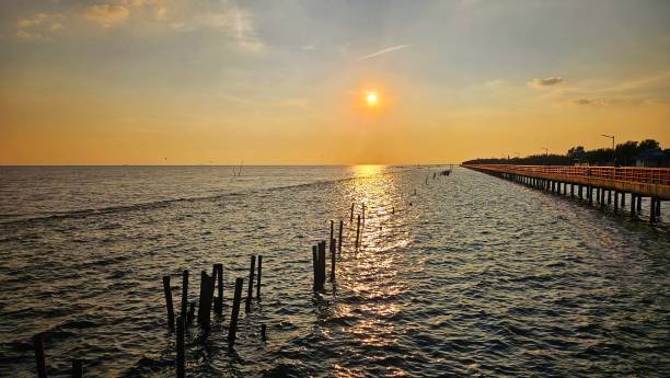 istock Sunset view at sea shore with red bridge walk way landscape, Thailand. 2181636514