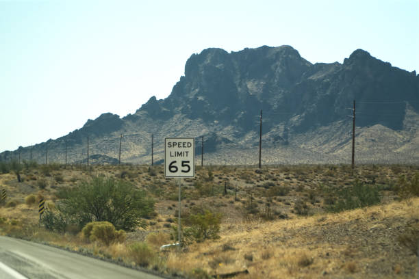 istock SPEED LIMIT 65  Sign board Mountain View Background 2181637108