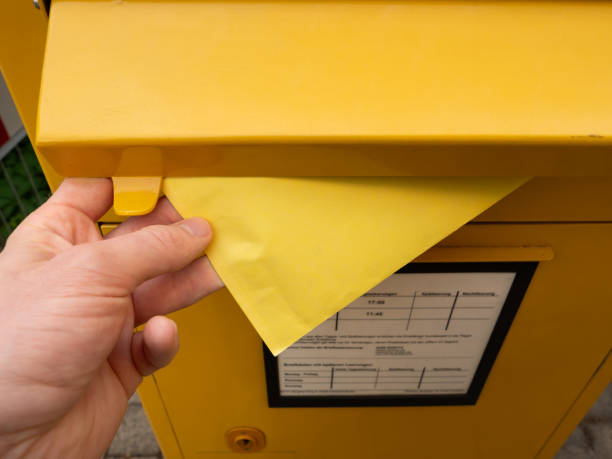 istock Posting a Yellow Letter into a Mailbox im Germany 2181640271